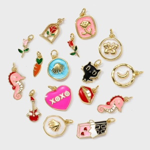 Selection of colorful enamel charm pendants in moon, rose, and cat shapes for DIY jewelry