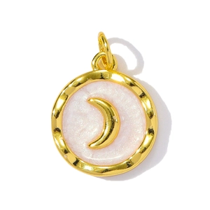 Close-up of golden round moon pendant with pink pearlescent base and crescent detail