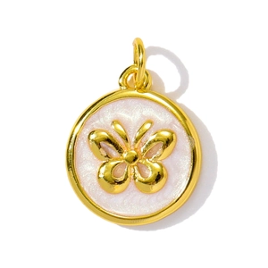 Close-up of golden butterfly pendant with pink pearlescent enamel for DIY jewelry