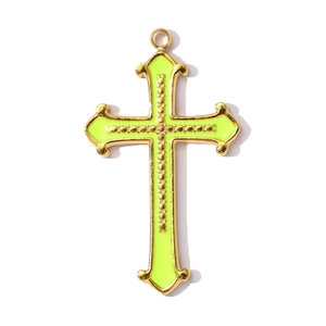 Detailed view of neon yellow cross pendant with golden metal edges and beaded center