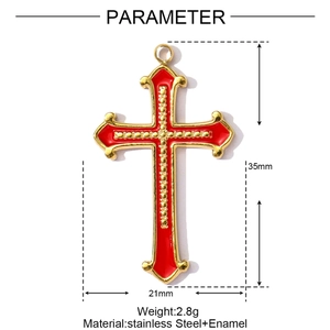 Detail of a 35mm gold-toned stainless steel cross pendant with red enamel inlay