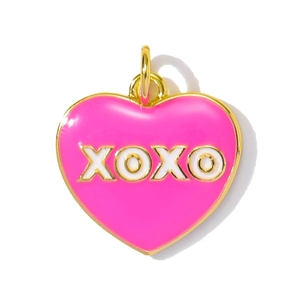 Close-up of heart-shaped pink enamel pendant with golden XOXO design and metal loop