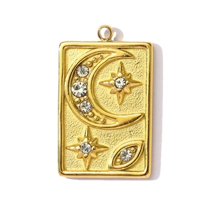 Detailed shot of golden rectangular pendant with celestial moon and star engravings
