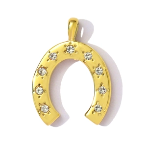 Macro view of gold-plated horseshoe pendant with nine clear inlaid crystals and top ring