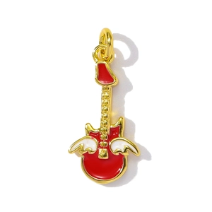 Macro view of a red enamel guitar pendant with white wings and gold-plated details
