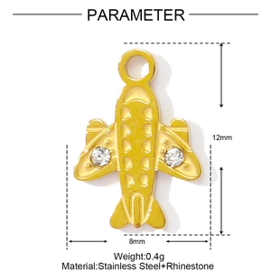 Detail view of a gold airplane pendant in stainless steel with crystal rhinestones