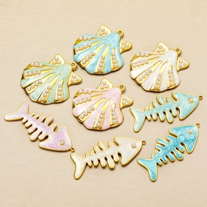 Tropical sea shell and fish bone pendants in gold-plated steel with colorful enamel finish