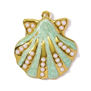 Macro detail of mint green enamel shell pendant with white pearls on gold plated steel