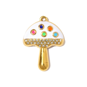 Macro detail of gold mushroom pendant with colorful polka dots and inlaid crystals