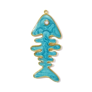 Macro view of fishbone pendant with blue enamel, sparkling glitters and pearl detail
