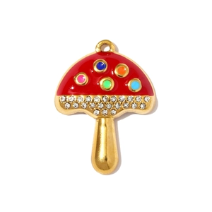 Detailed close-up of a mushroom pendant with red enamel and sparkling white crystals
