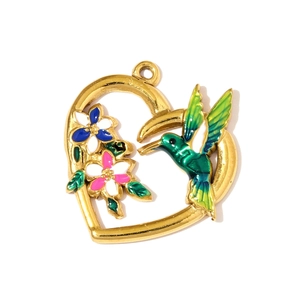 Detailed view of heart-shaped gold-plated hummingbird pendant with floral colorful enamel