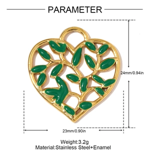 Macro view of gold heart pendant with green enamel leaf inlay and stainless steel frame