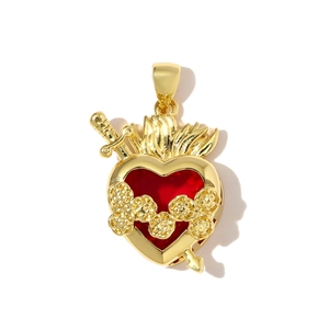 Detailed view of a golden sacred heart pendant with red core and rose floral accents