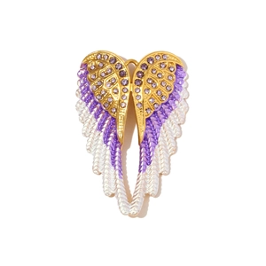 Detailed view of gold stainless steel angel wing pendant with purple crystals