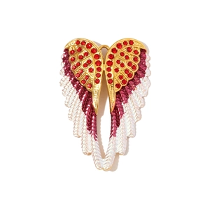 Detail showing red rhinestones and purple gradient enamel on the gold wing pendant
