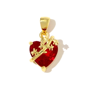 Macro detail of gothic dark red heart pendant with golden thorn wrap decoration