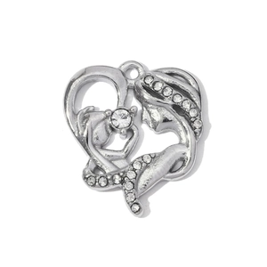 Detailed macro view of heart-shaped stainless steel pendant with mother and baby silhouette