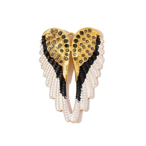 Macro detail of angel wing pendant with rhinestones and enamel on stainless steel