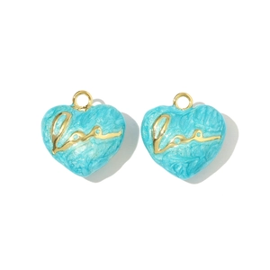 Detailed view of sky blue marble heart charms with gold 'Love' script and metal loop