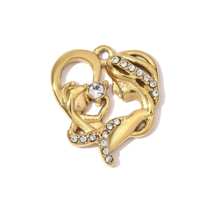 Detail of gold heart pendant with crystal stones and mother-child silhouette