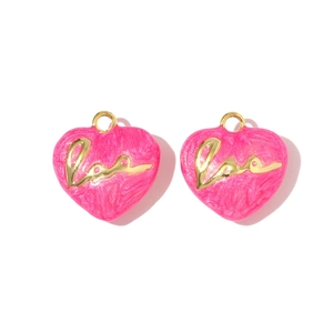 Detail of two dark red heart pendants with golden Love script and top jump rings