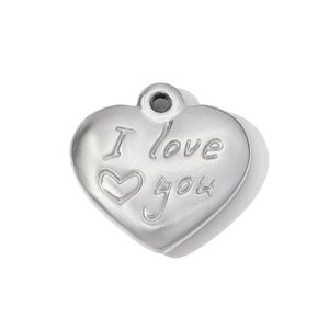 Macro detail of silver stainless steel heart pendant with I Love You engraved message