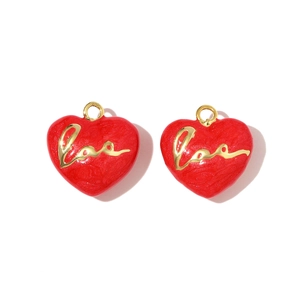 Macro view of red heart charms with gold Love lettering and glitter enamel finish