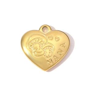 Macro shot of gold-plated heart pendant with NANA lettering and mushroom pattern