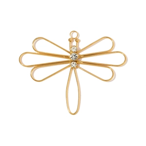 Macro view of gold dragonfly pendant with sparkling cubic zirconia on stainless steel wings