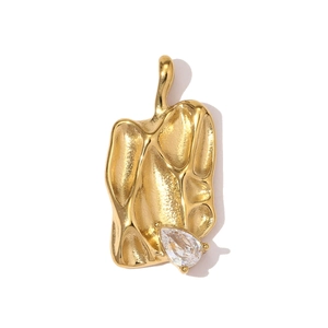 Detailed view of a gold-plated irregular lava texture pendant with teardrop zircon stone
