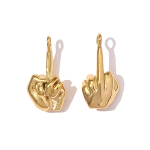Macro shot of two polished gold-plated middle finger pendants with smooth metallic texture