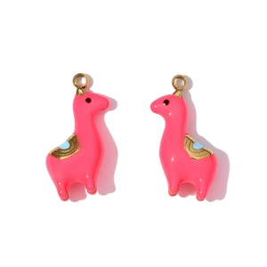 Detailed macro shot of pink enamel alpaca pendants with gold metal saddle and top loop