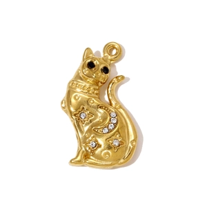 Macro detail of a gold Egyptian cat pendant featuring star and moon engravings with rhinestones