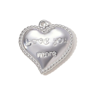 Close-up of heart-shaped silver pendant with Love You More engraving and beaded edge