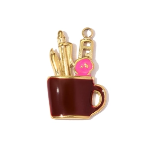 Detailed view of a red enamel pen holder pendant with pencil and donut charm