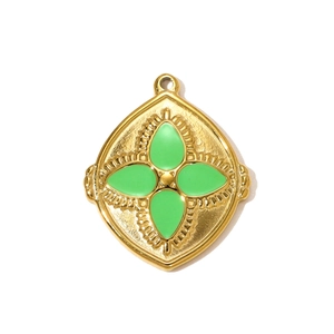 Detailed view of a gold-plated stainless steel pendant featuring green enamel clover