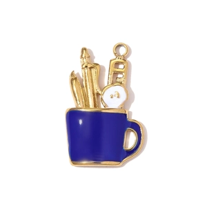 Detail of blue enamel mug pendant with stationery tools and a golden hanging loop