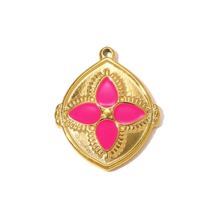 Detail of vintage gold-plated pendant with rose pink four-petal clover and embossed frame