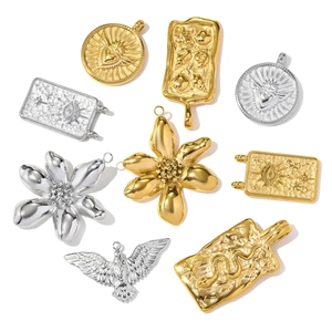 Assorted stainless steel gold and silver pendants featuring floral, snake and heart designs