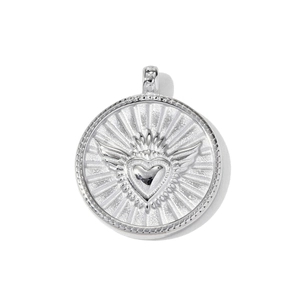 Macro detail of silver stainless steel pendant with embossed winged sacred heart motif