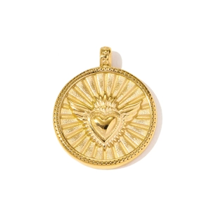 Detail view of round golden stainless steel pendant with winged heart and sunburst relief