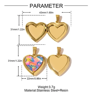 Detail view of heart-shaped stainless steel locket showing open and closed states