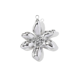 Detailed macro view of a polished stainless steel flower pendant with intricate petal texture