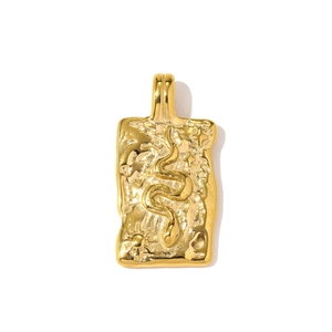 Detail of a rectangular gold pendant featuring an embossed snake and celestial sun motifs