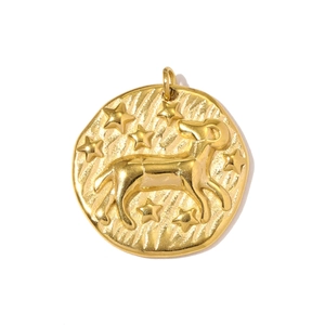 Detailed relief of a gold Aries zodiac pendant with stars and sunburst texture