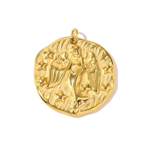 Detailed relief of a gold angel wing pendant with stars on hammered stainless steel