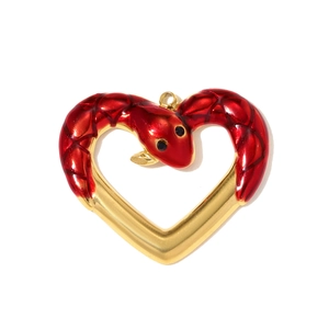 Detailed close-up of heart-shaped snake pendant with red enamel finish and golden metal base