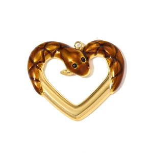 Detailed macro view of heart-shaped gold pendant with brown enamel snake texture