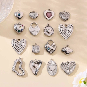 Polished heart shaped metal pendants in 16 designs featuring wings and love engravings